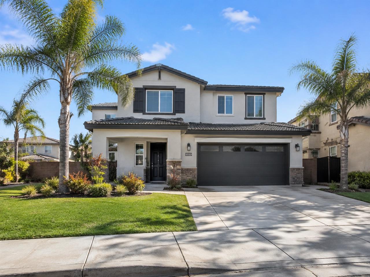 Modern two-story home with palm trees